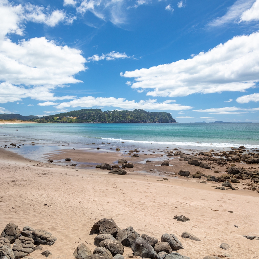 Scenic view of Hot Water Beach, a popular tourist destination in New Zealand known for its hot springs under the sand.
